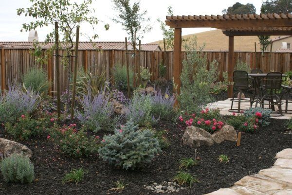 A garden with a pergola and a table and chairs | Landscape Design in Davis, CA
