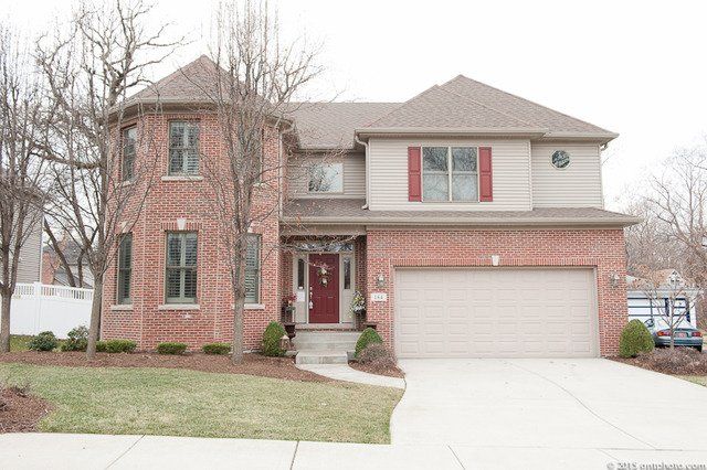 A large brick house with a white garage door