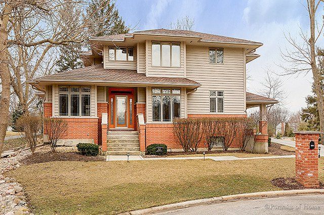 A large house with a lot of windows is for sale.