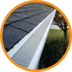 Gutter with mesh guard on a roof, preventing debris from entering.