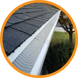 Gutter with mesh guard on a roof, preventing debris from entering.
