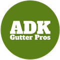 ADK Gutter Pros logo: white text on a green circle, reading