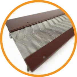 Brown metal eavestrough with a zig-zag metal mesh guard.