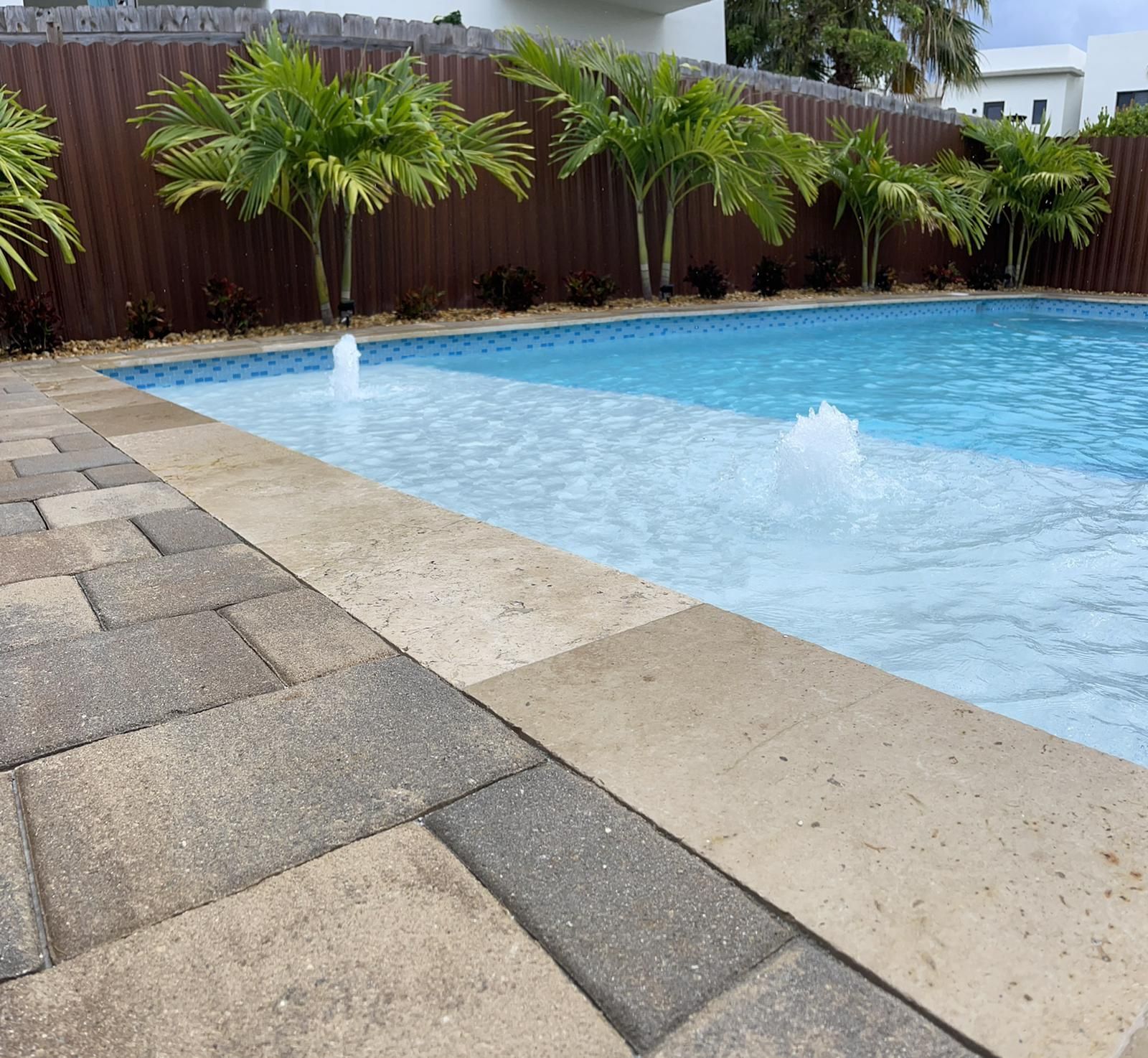 A large swimming pool with a fountain in the middle