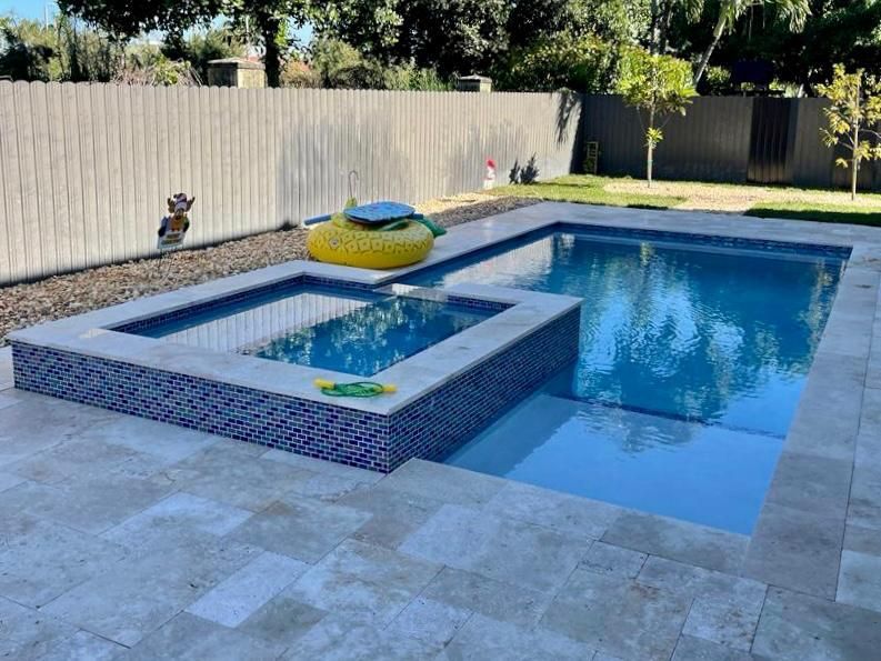 A large swimming pool with a yellow raft in it.