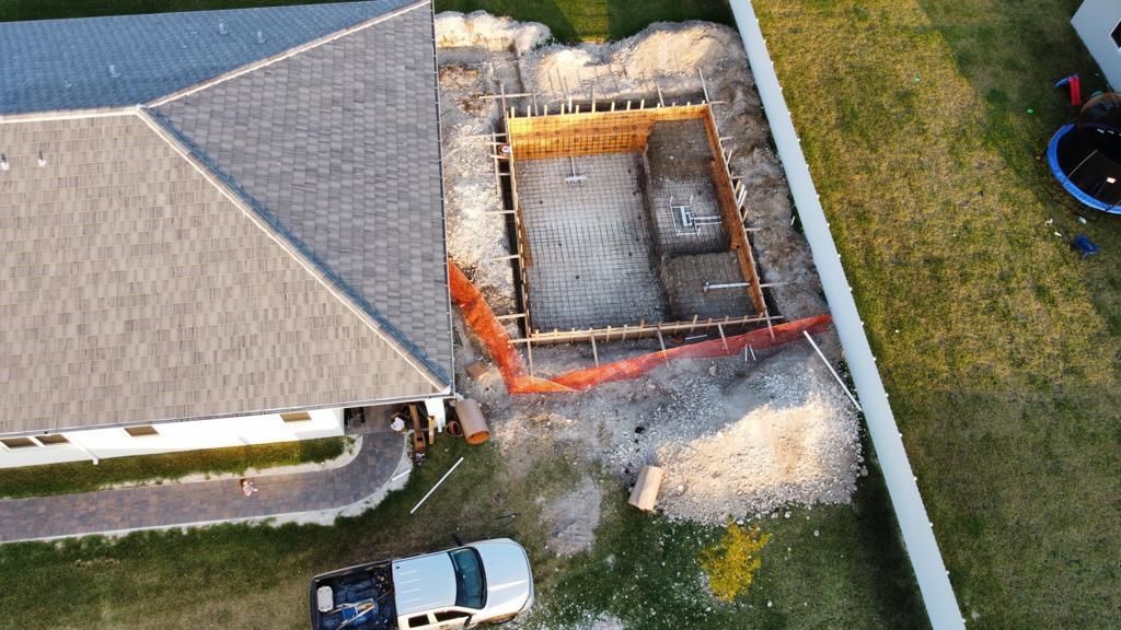 An aerial view of a house under construction with a truck parked in front of it.