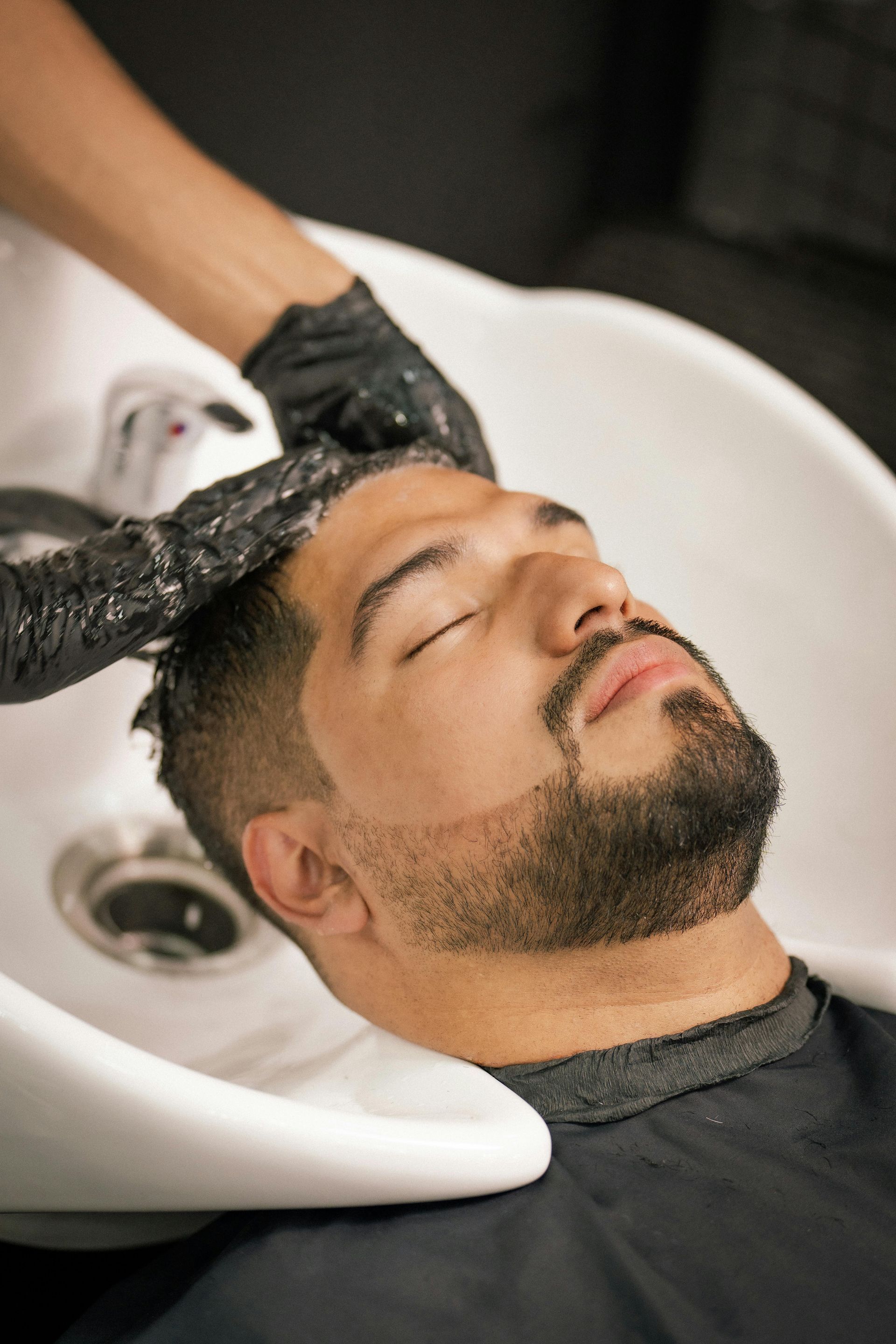 Person getting hair washed at the legendary right touch barbershop in Colorado Springs, Co.