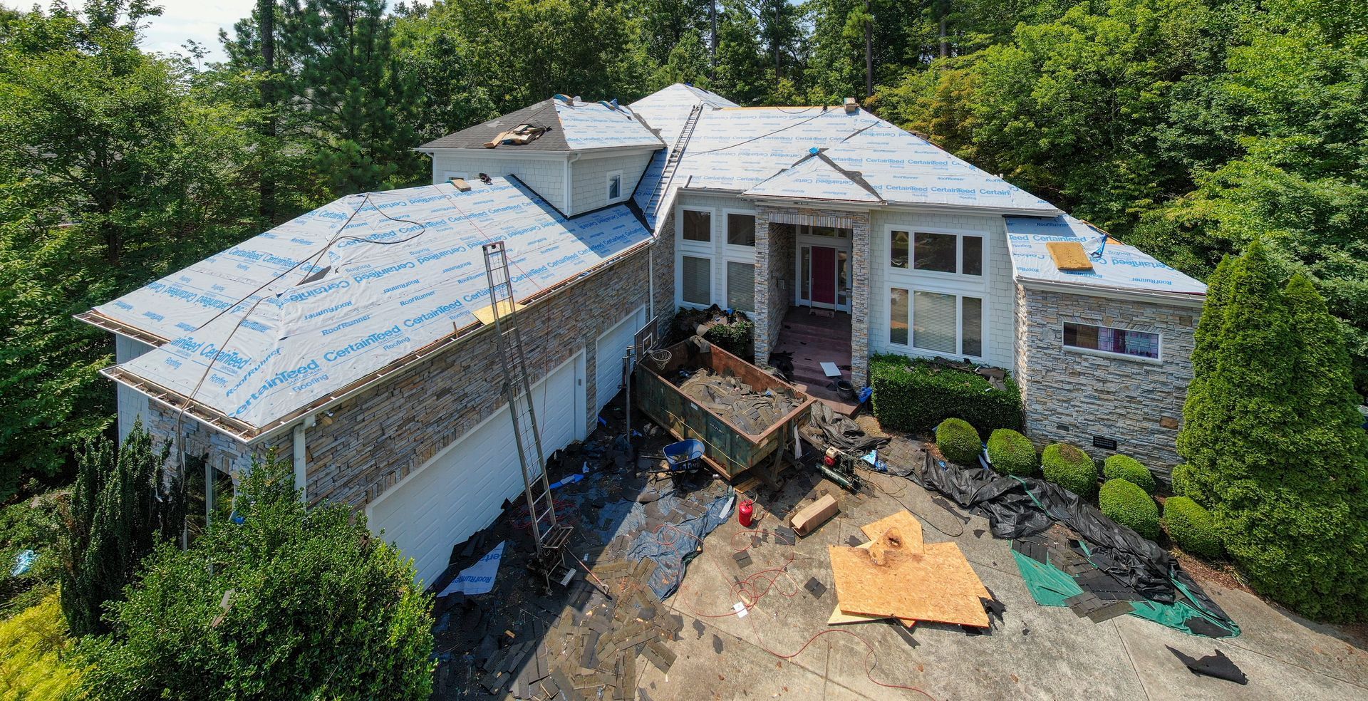 An aerial view of a large house under construction.