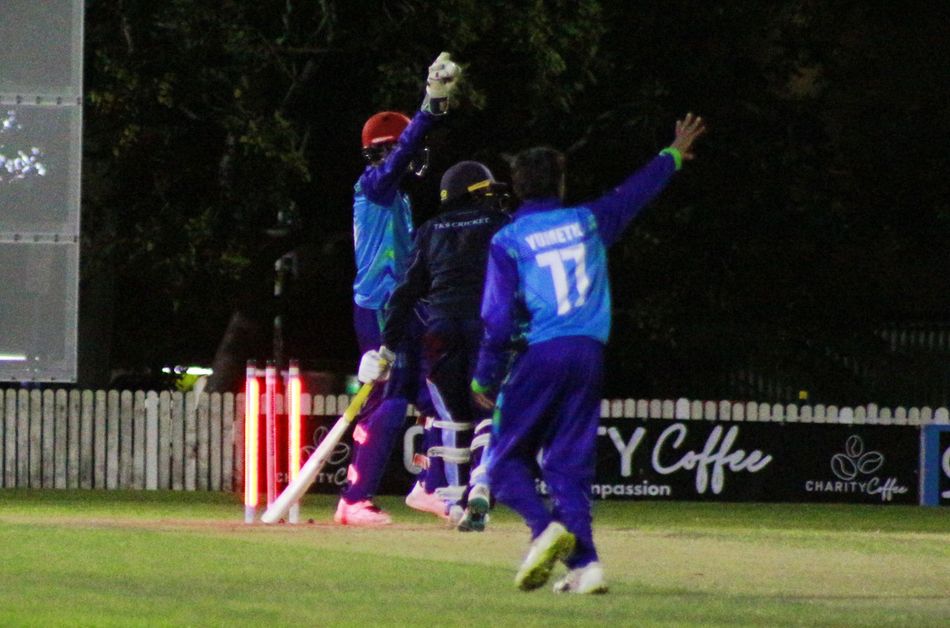 Two cricket players are playing a game of cricket on a field.