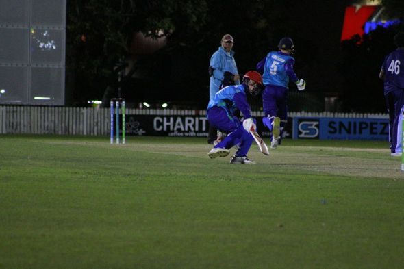 A man wearing a jacket that says lions cricket on the back