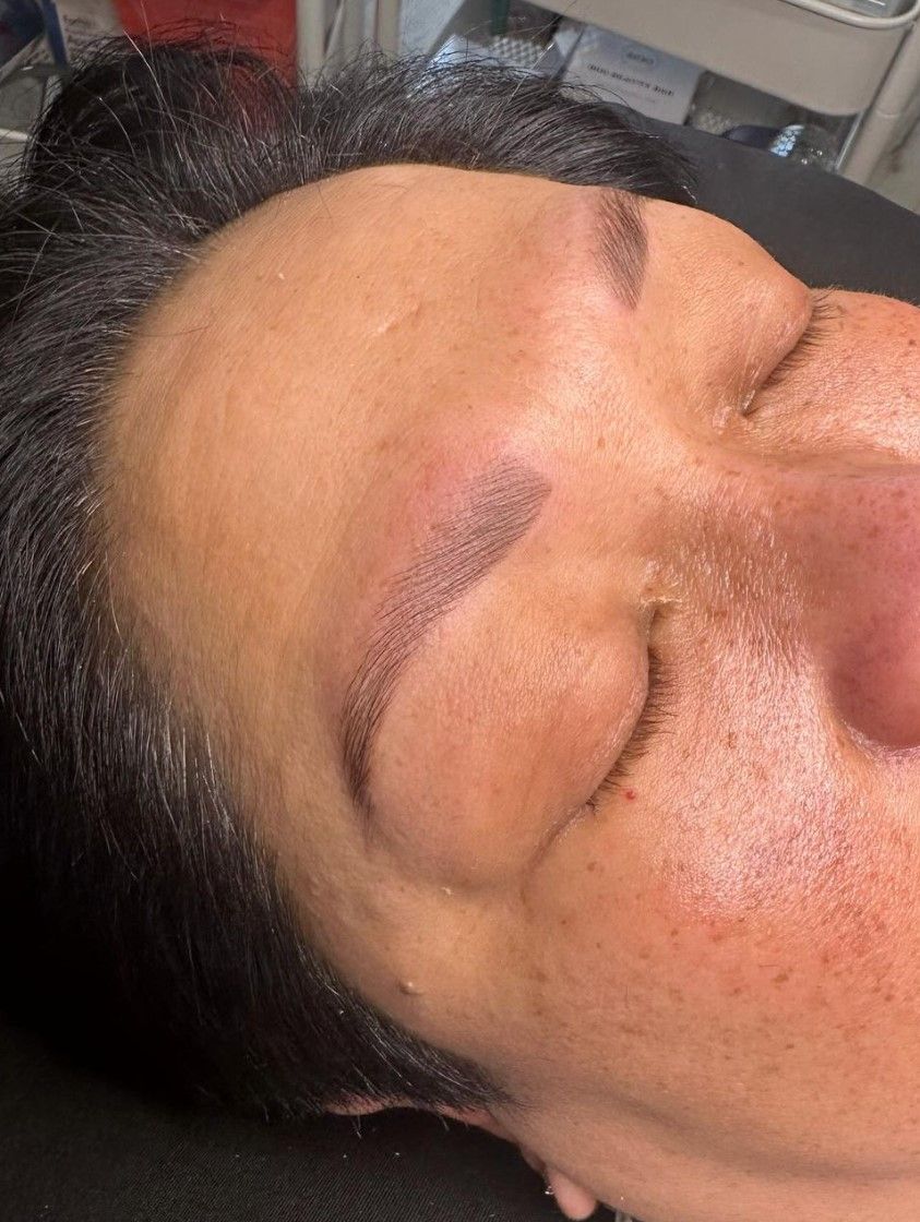 A close up of a woman 's face with her eyes closed.