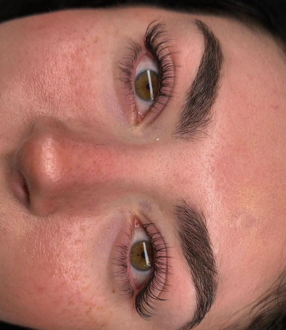 A close up of a woman 's face with her eyes closed.
