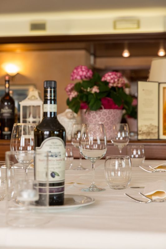 A bottle of wine is sitting on a plate on a table.