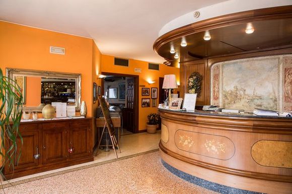 A hotel lobby with a round wooden counter