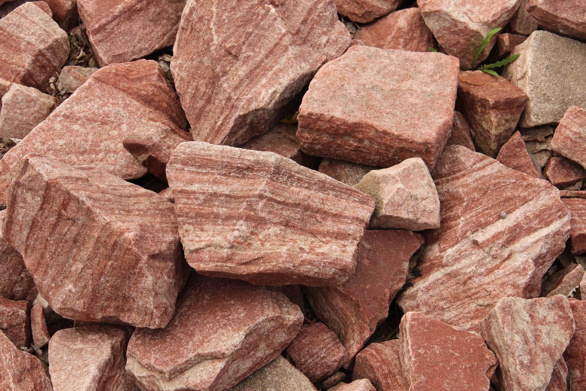 Red and tan sandstone rocks, with layered texture and rough edges. Red and tan sandstone rocks, with layered texture and rough edges.