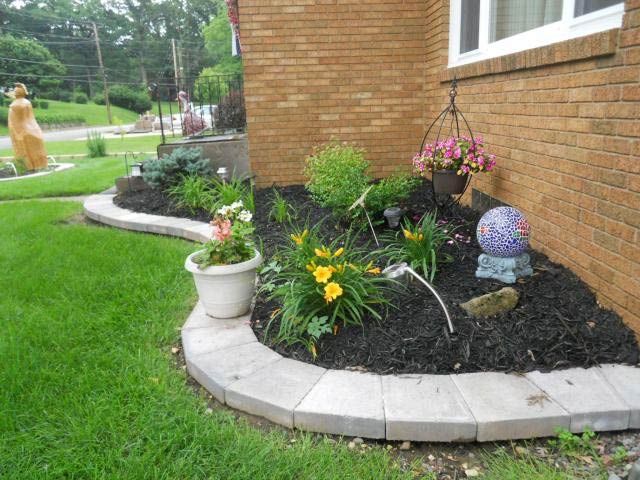 A Brick House With a Garden in Front of It - Orion, IL - C & J Landscaping