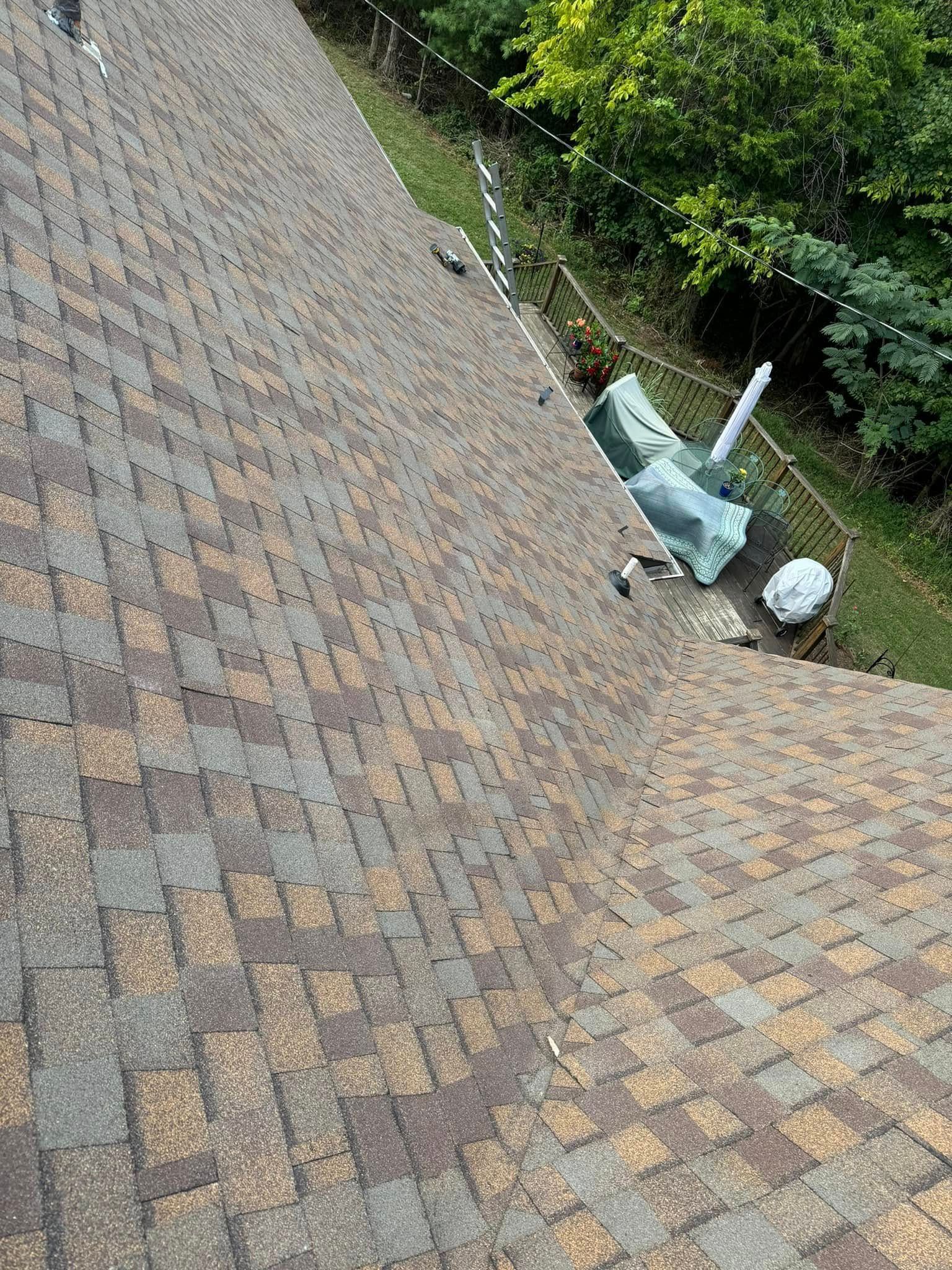 A close up of a roof with a lot of shingles on it.