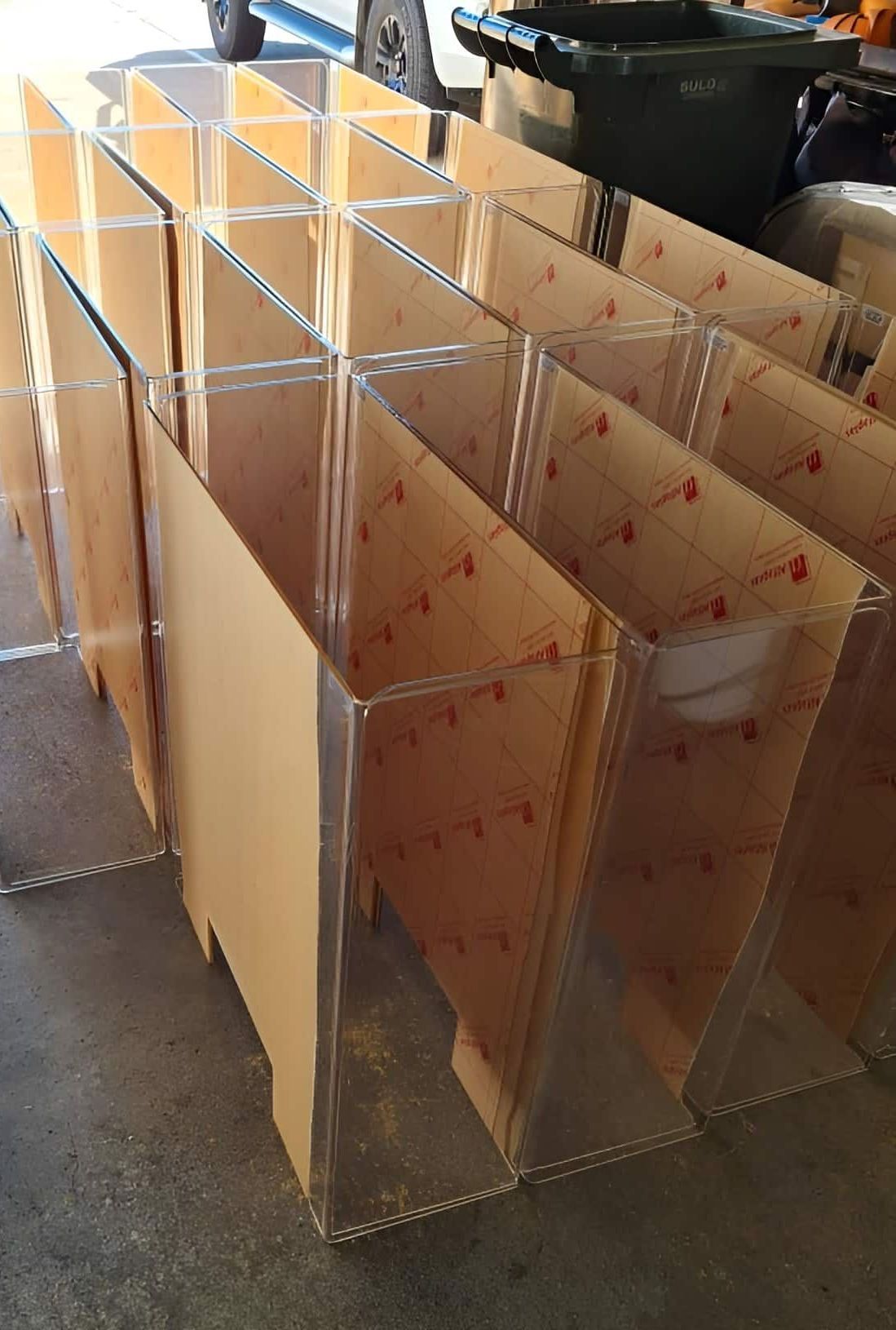 A Bunch Of Clear Acrylic Boxes Are Sitting On The Ground — Ram Star Plastics In Winnellie, NT