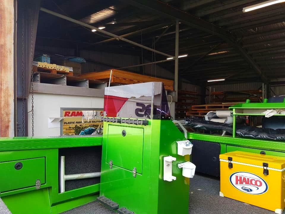 A Green Machine Is Sitting In A Warehouse — Ram Star Plastics In Winnellie, NT