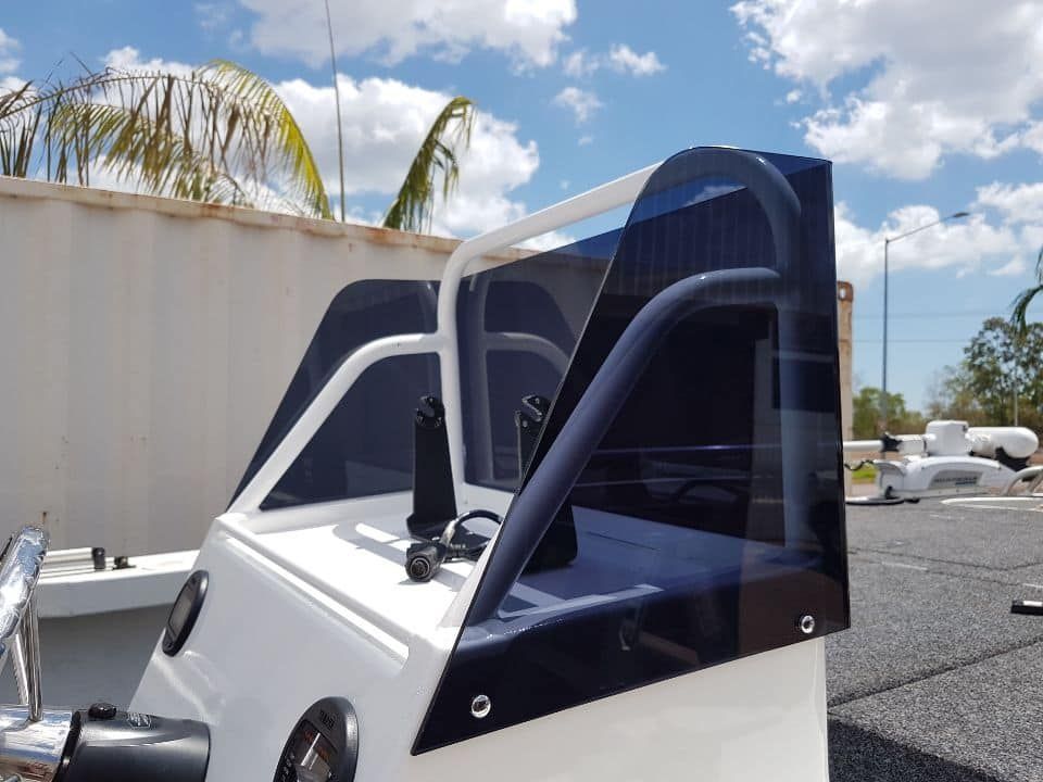 A White Boat With A Clear Windshield Is Parked In A Parking Lot — Ram Star Plastics In Winnellie, NT