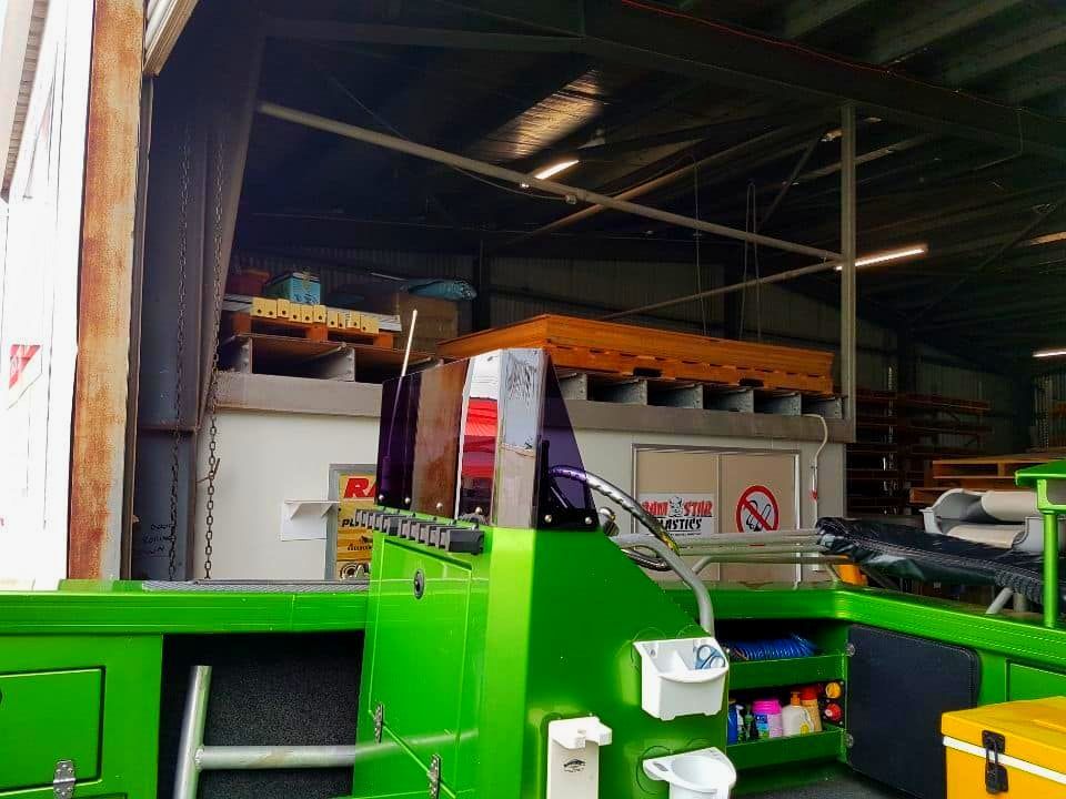 A Green Machine Is Sitting In A Warehouse Next To A Yellow Box That Says Haco — Ram Star Plastics In Winnellie, Nt