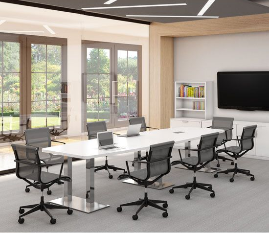 Conference room with white table, black chairs, and large screen, windows in background.