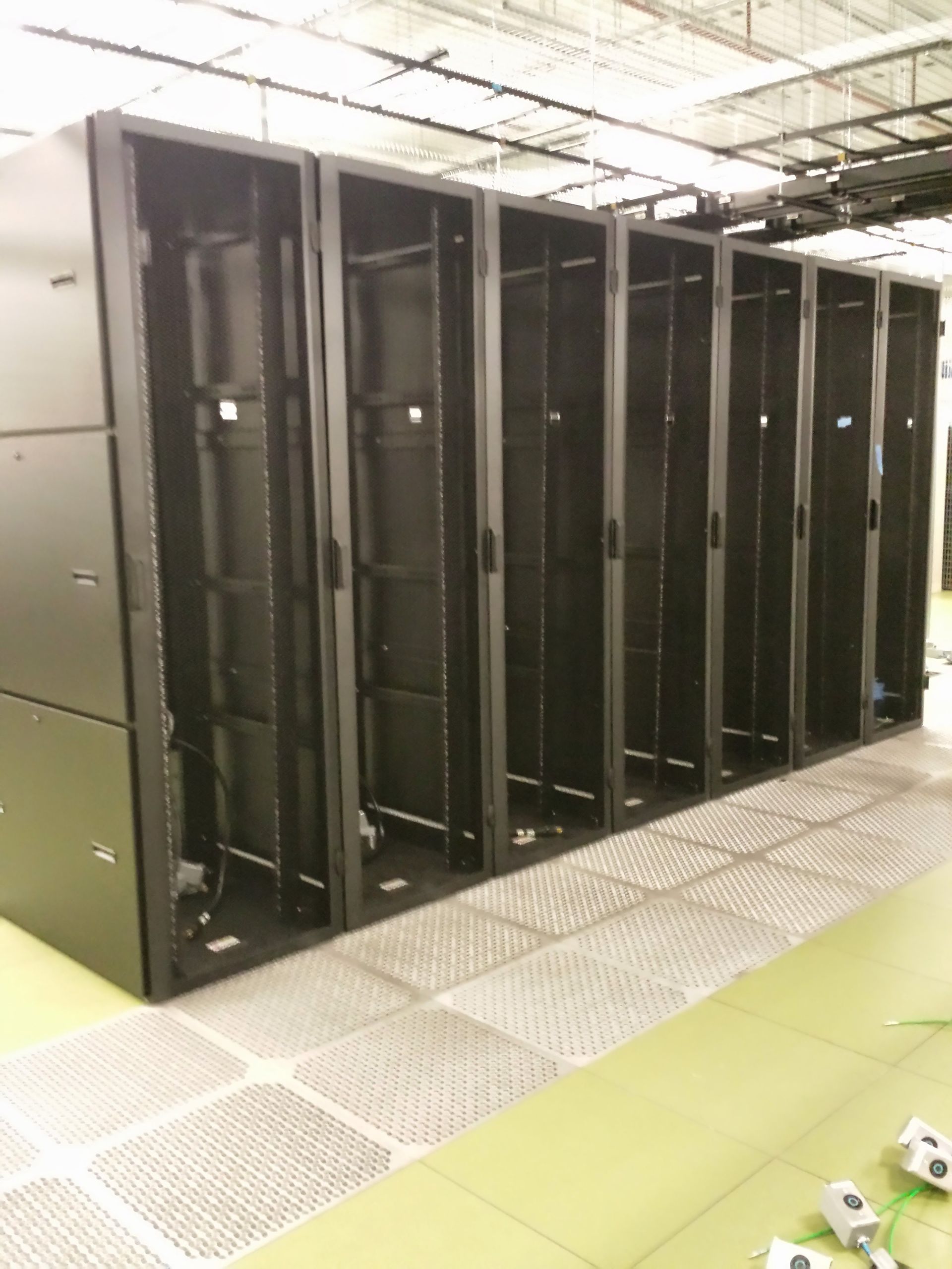 Empty black server racks lined up in a data center.