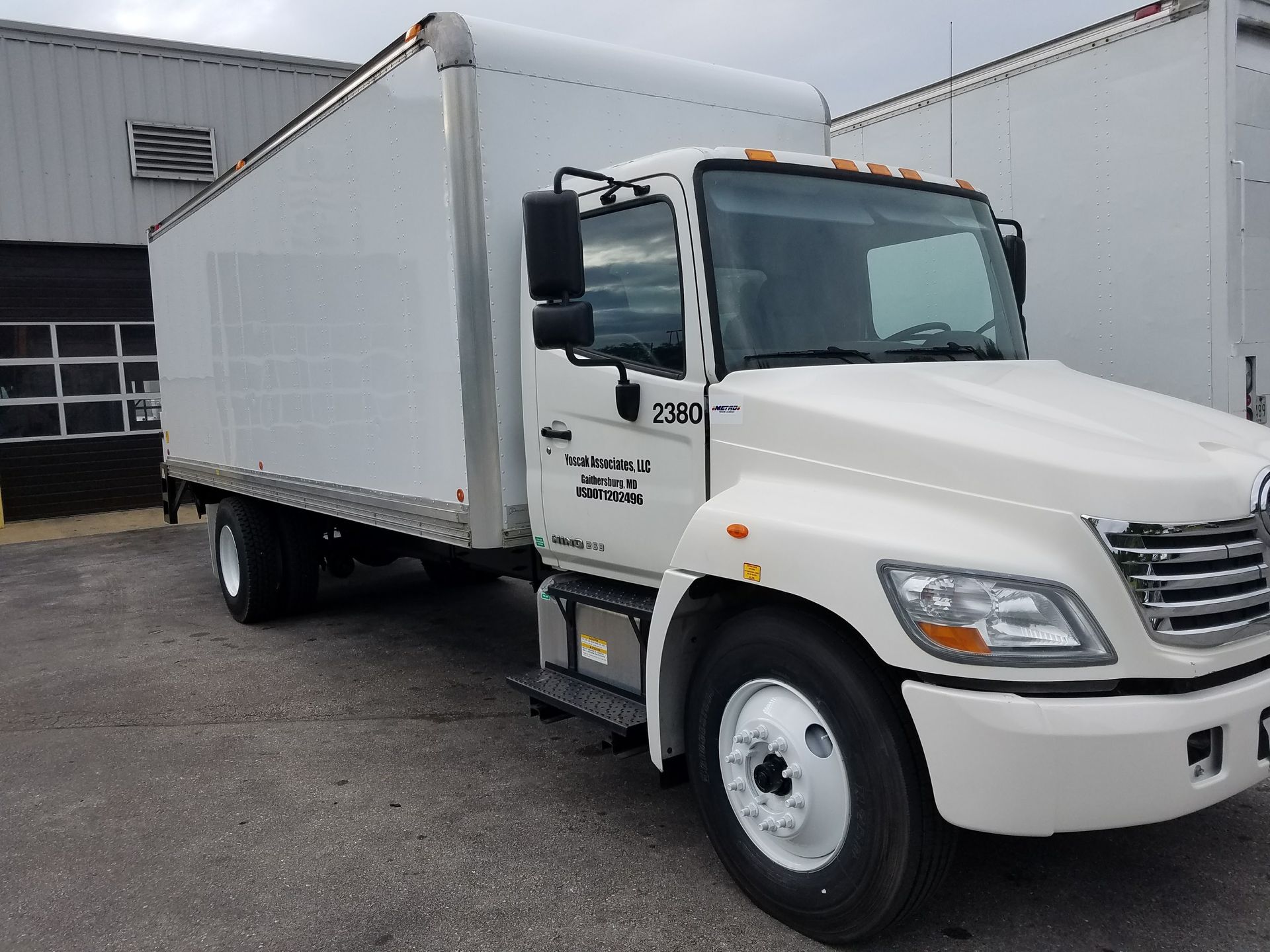 White box truck parked outdoors.