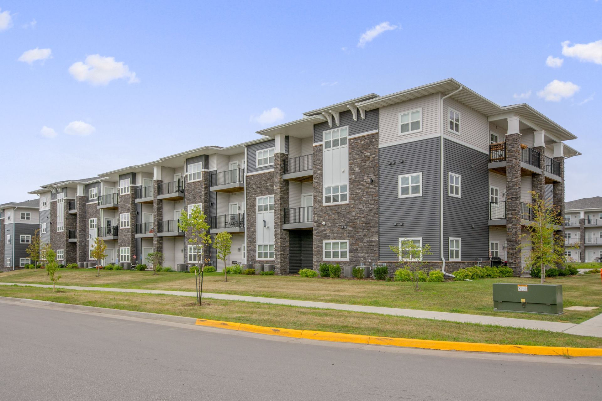 Exterior view of Aurora Heights, a modern apartment complex in Ames, IA offering convenient living spaces close to local & ISU amenities.