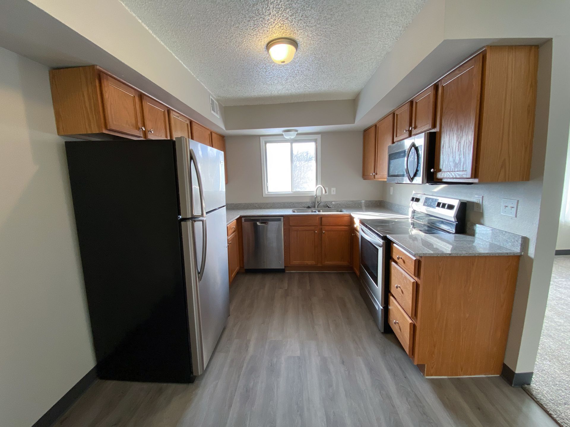 Interior view of a modern apartment unit at Unique Apartment Homes in Ames, IA, featuring spacious living areas and contemporary finishes