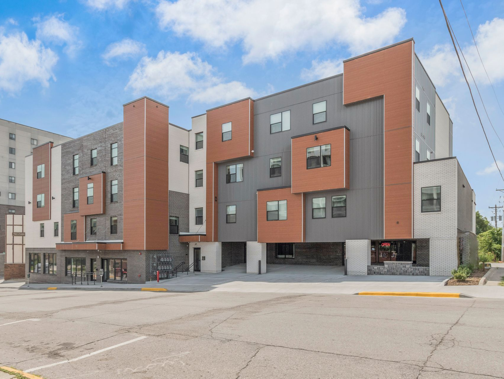 Exterior view of Clocktower Place, a modern apartment building in Ames, IA offering convenient living spaces close to ISU amenities.