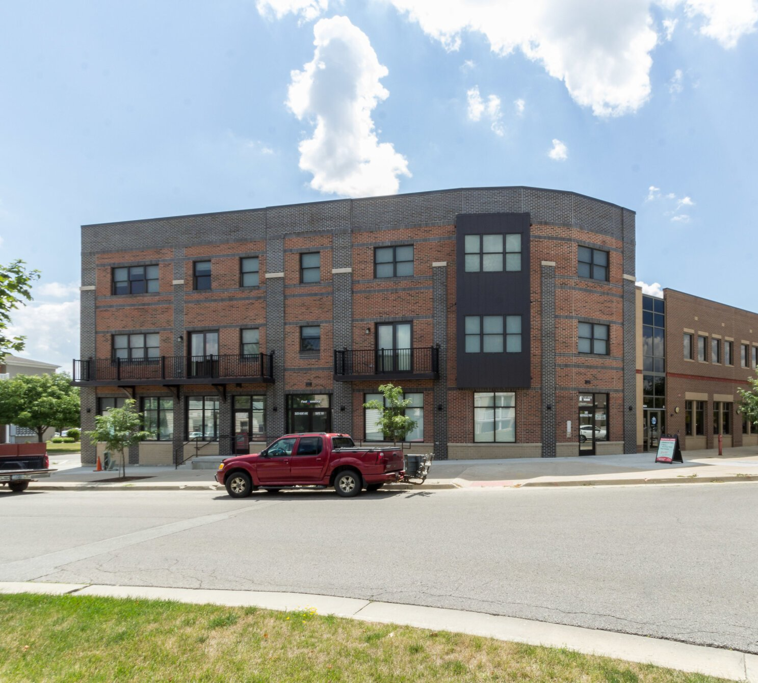 Exterior view of Flatiron Lofts, a modern apartment building in Ames, IA offering convenient living spaces close to local & ISU amenities.