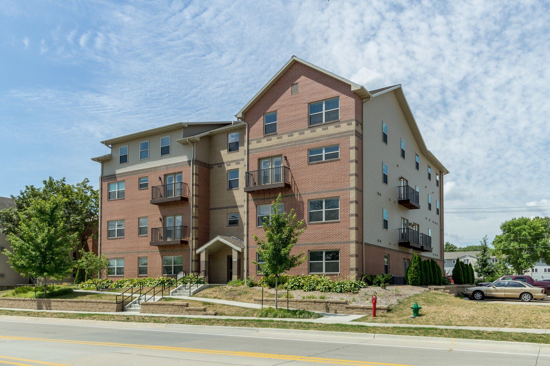 Exterior view of Triangle Apartments, a modern apartment building in Ames, IA offering convenient living spaces close to ISU amenities.
