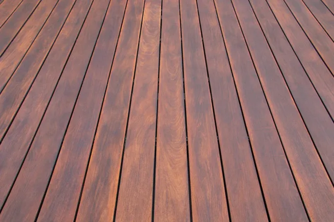 Wooden deck boards with warm brown planks arranged in long parallel lines
