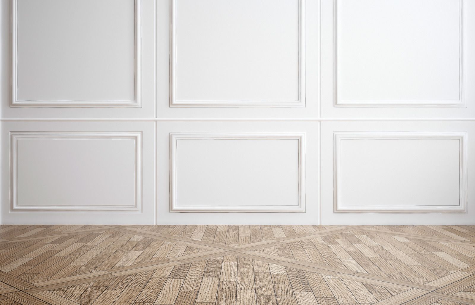 White paneled wall above a light wood floor in a clean, empty room.