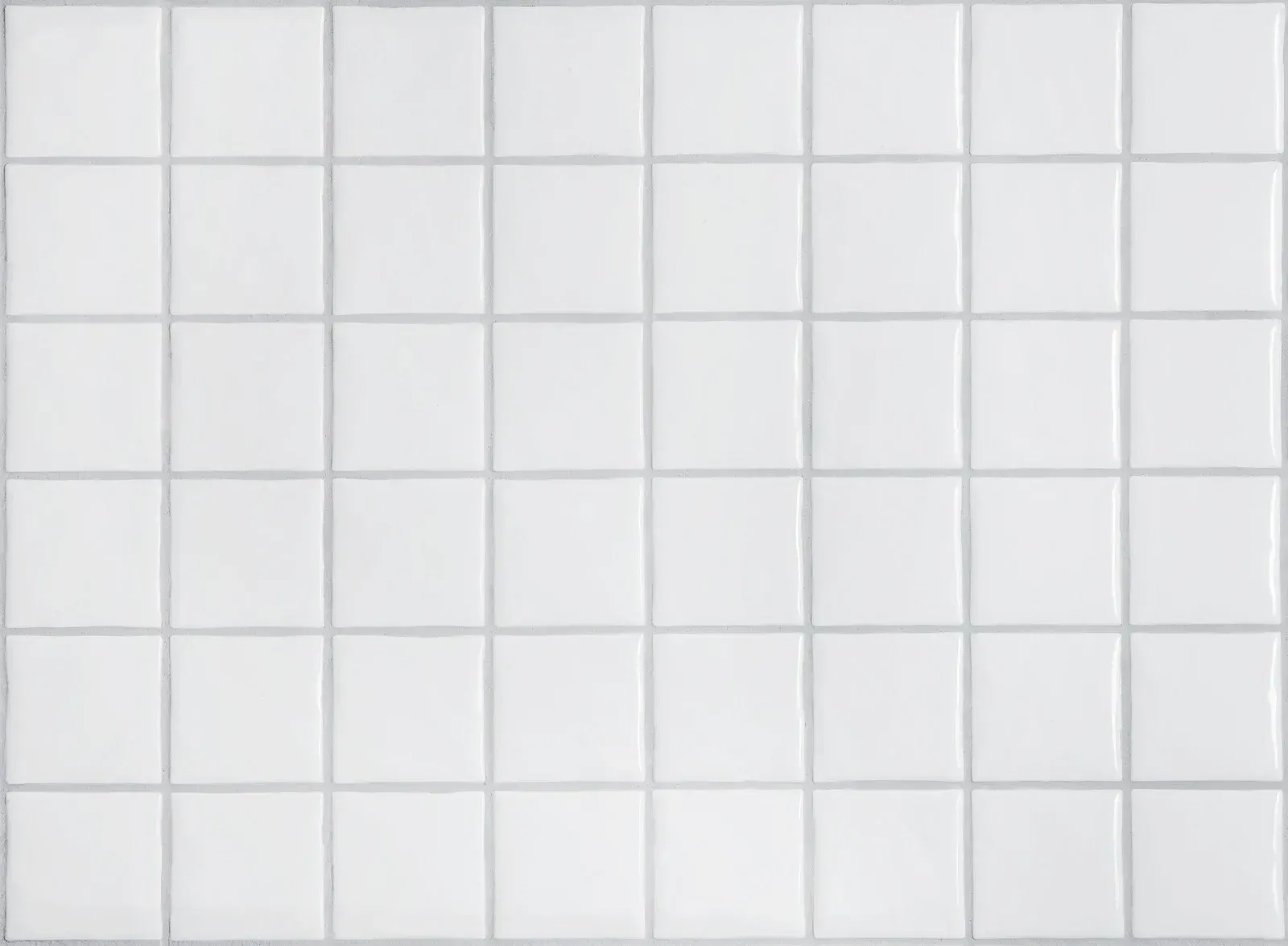 White square tile wall with light gray grout lines forming a grid.