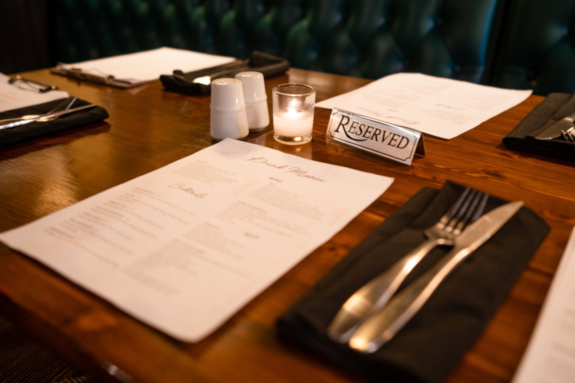 A wooden table with a reserved sign on it