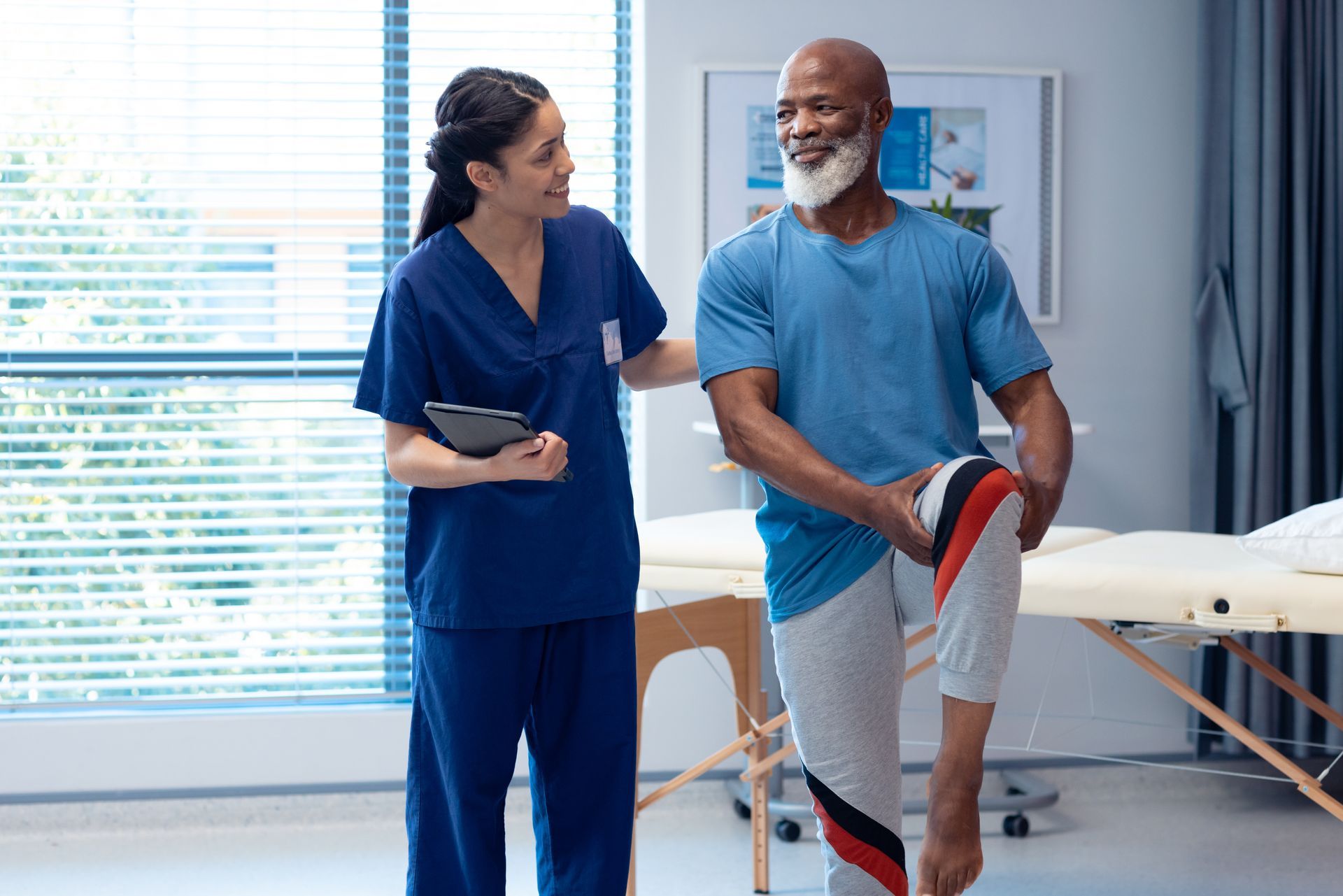 Physical therapist assisting a patient with leg stretches in a bright clinic room Physical therapist assisting a patient with leg stretches in a bright clinic room