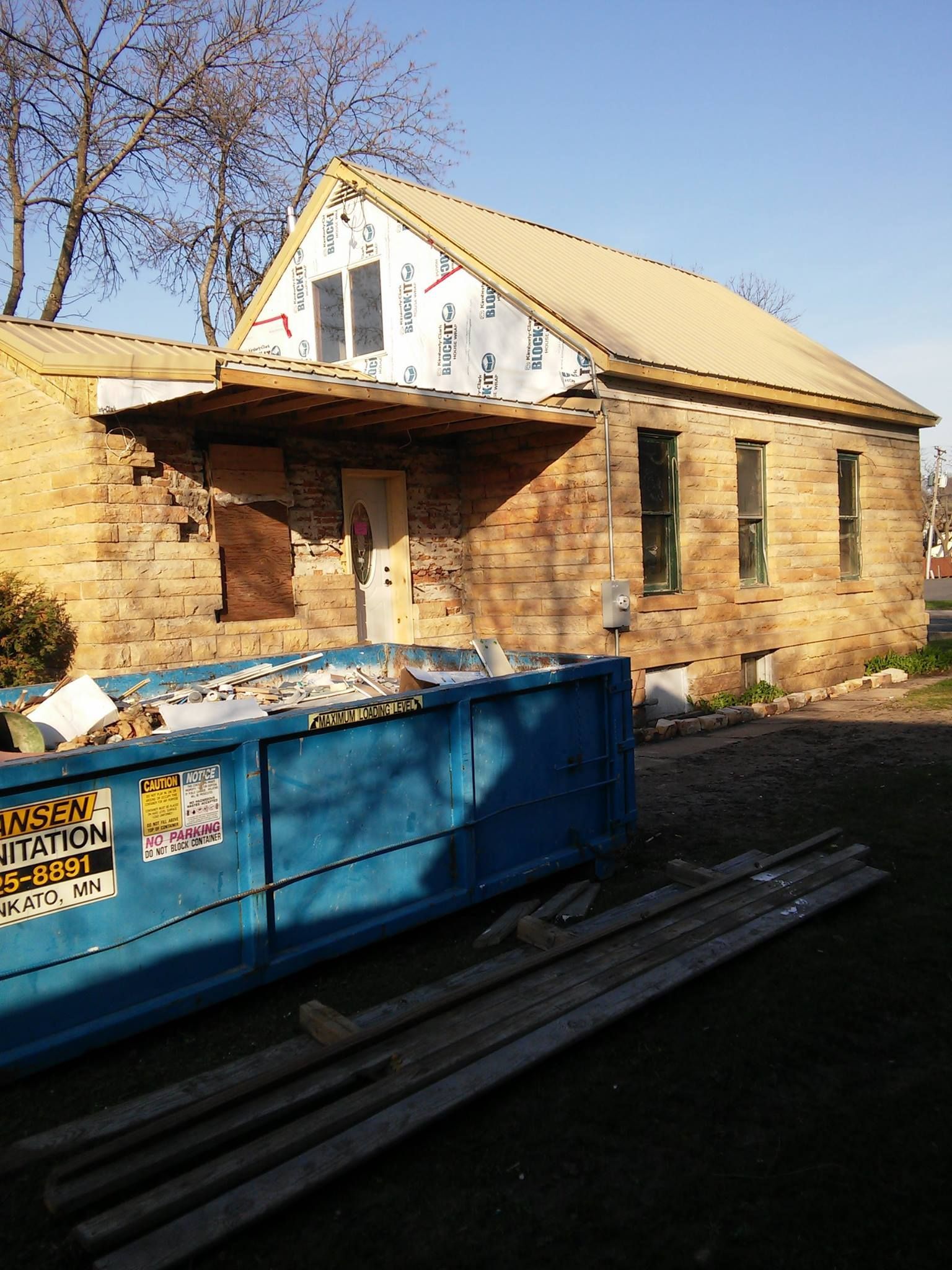 A blue dumpster with hansen insulation written on it
