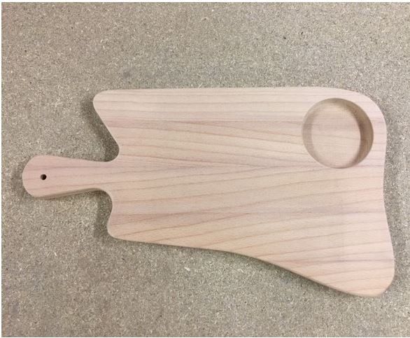 Tagliere in legno chiaro a forma di pagaia con foro e manico su superficie grigia
