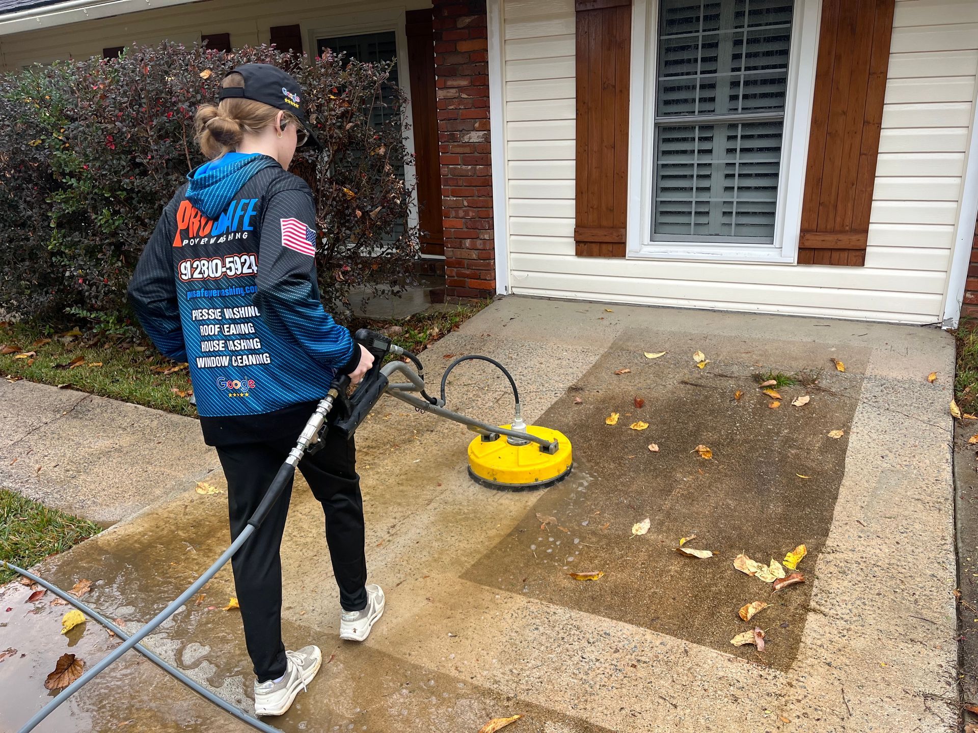 a woman is using a pressure washer to clean a sidewalk