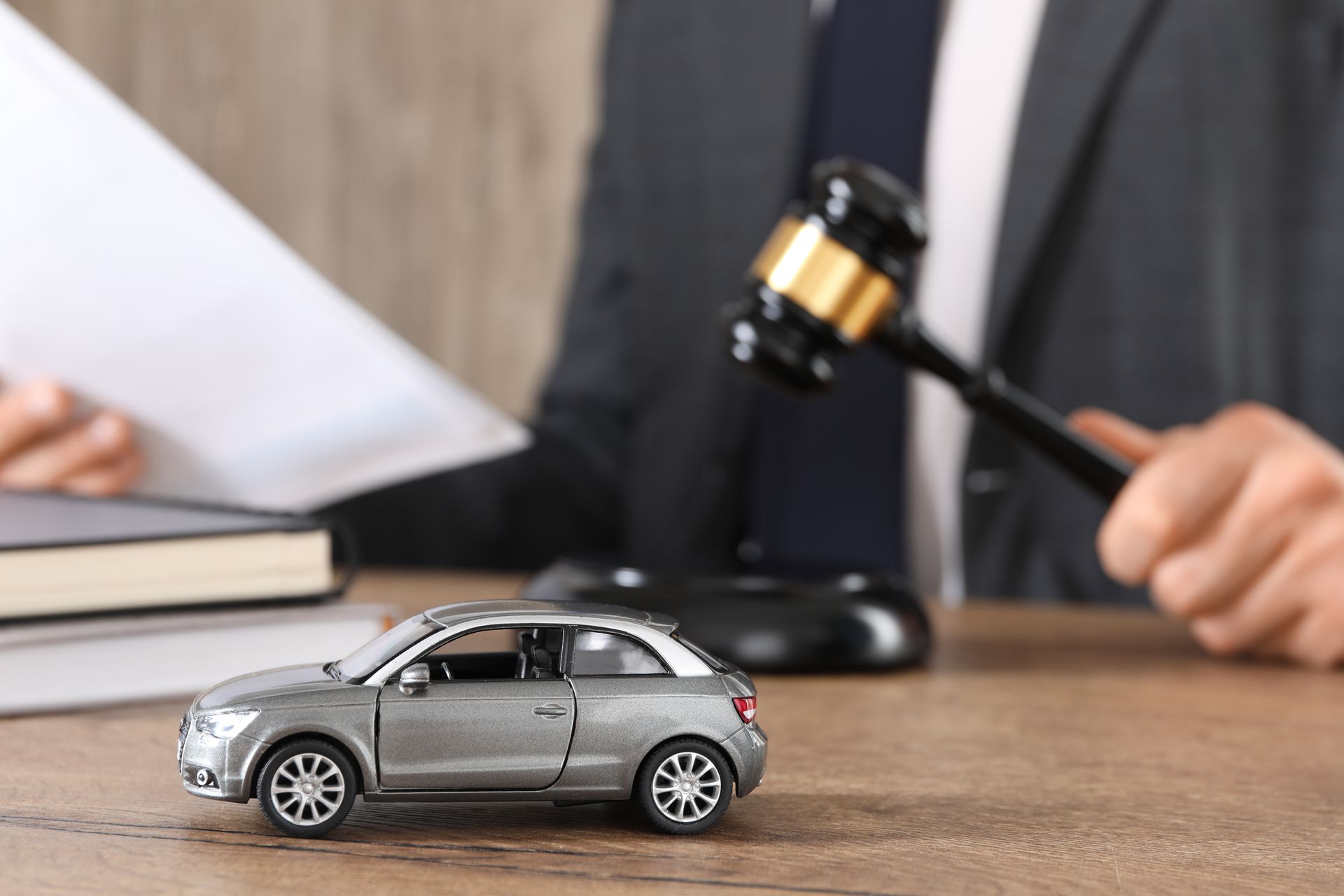 Man with document and gavel at wooden table indoors. Man with document and gavel at wooden table indoors.