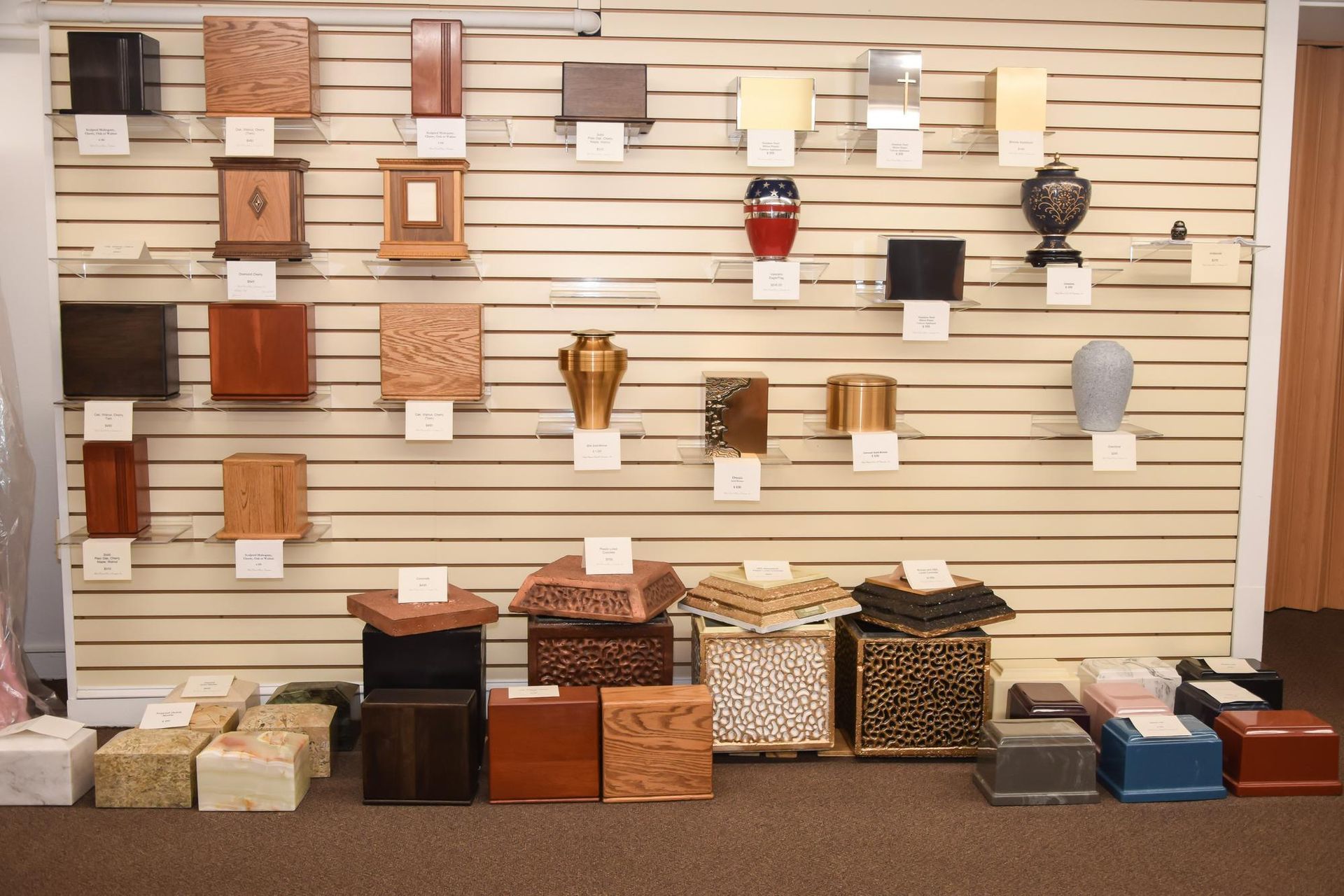 Wall display of assorted decorative lampshades and storage boxes in a home decor store