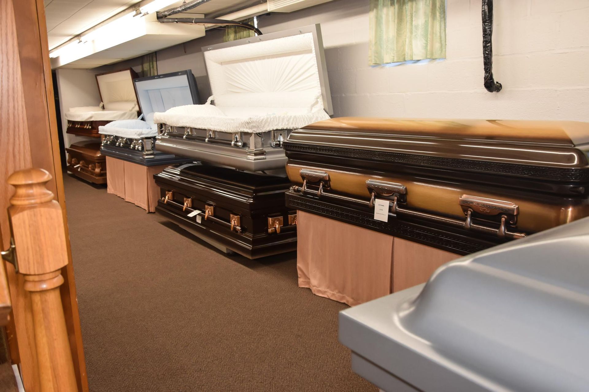Showroom with several mattresses and bed bases displayed in a row