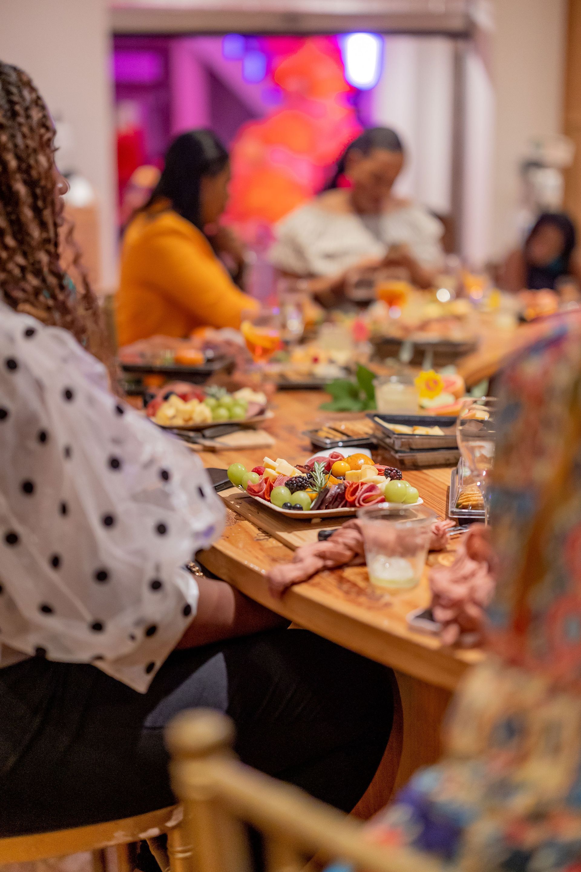 A group of people are sitting at a long table eating food.
