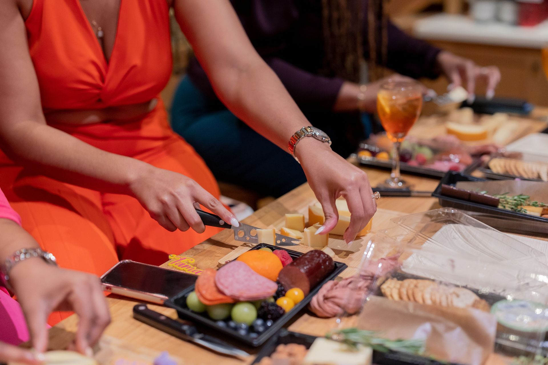A group of women are sitting at a table eating food.