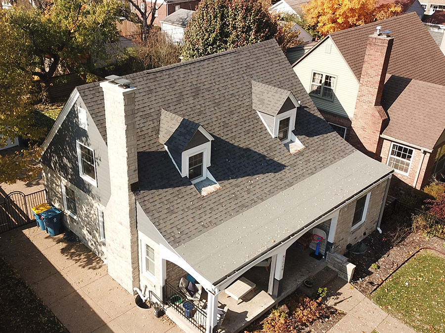 An aerial view of a house with a new roof.