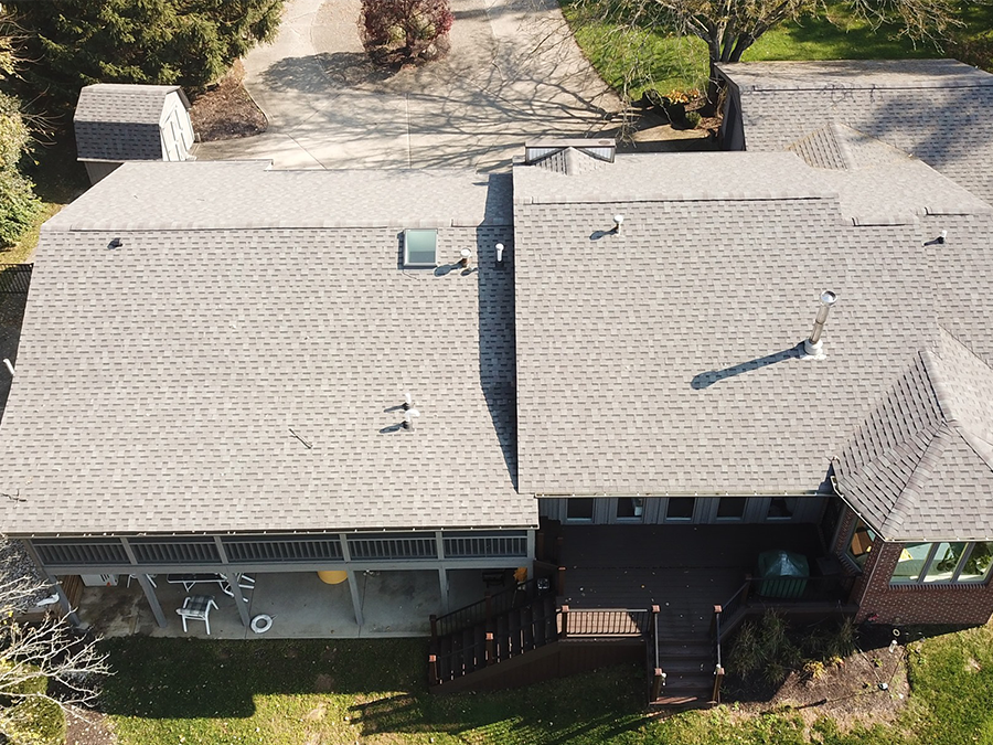 An aerial view of a house with a gray roof.