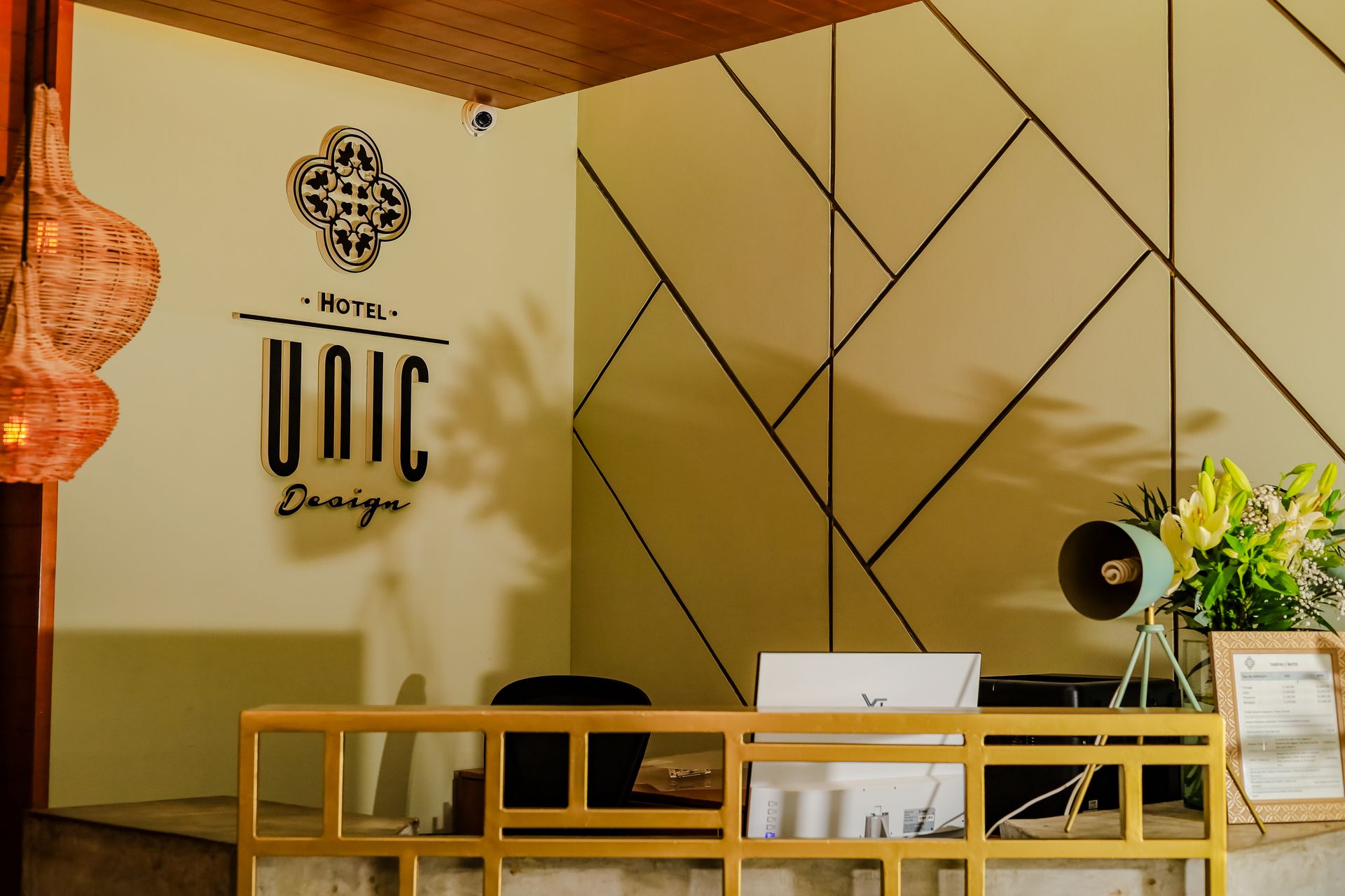 Hotel UNIC Design reception desk with geometric wall art and decor.
