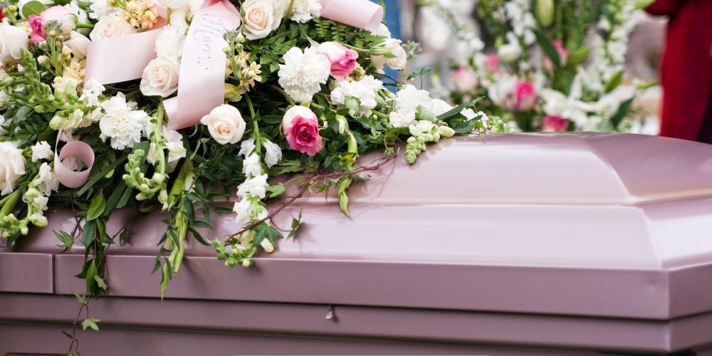 Funeral flower arrangement on casket at a memorial service provided by a funeral home and cremations in Willow Park, TX
